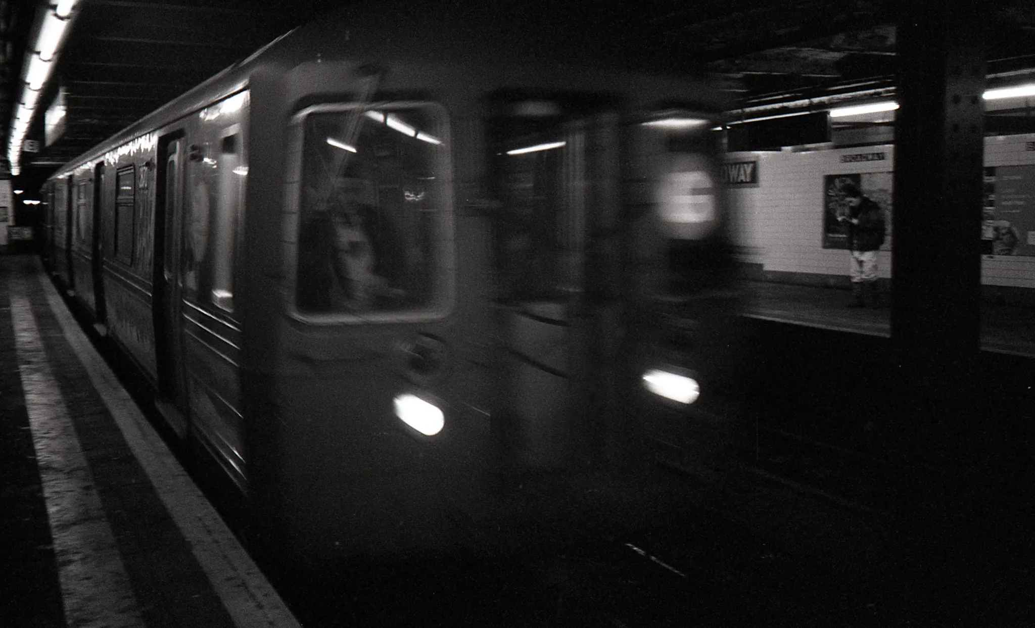 A subway train moves by in a station of New York City.